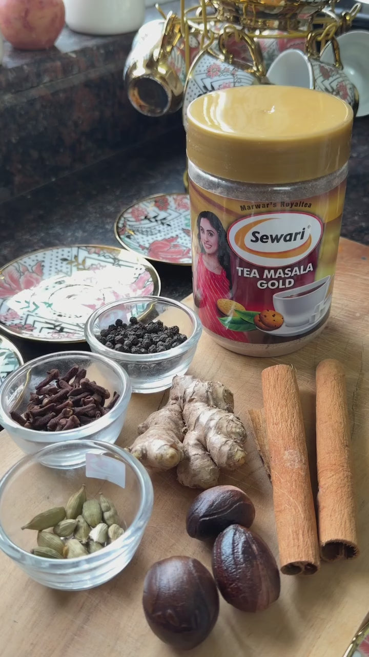 Sewari Tea Masala Gold Video. Shows Sewari Tea Masala Gold Bottle with all the ingredients, Shunthi (ginger), Maricha (black pepper), Ela (cardamom), Tvak/Dalchini (cinnamon), Jaiphal (nutmeg) and Lavanga (clove). The video then shows the entire process of making tea with the masala